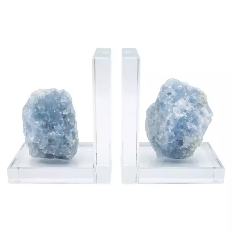 set-of-2-Blue-Calcite-book-ends-FE003_Z_1 Matched pair of natural blue calcite slab bookends with soft sky-blue banding and translucent crystalline surface, shown propping books