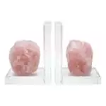 Matched set of two natural rose quartz slab bookends in soft pink with crystalline internal structure, shown propping books on plain surface