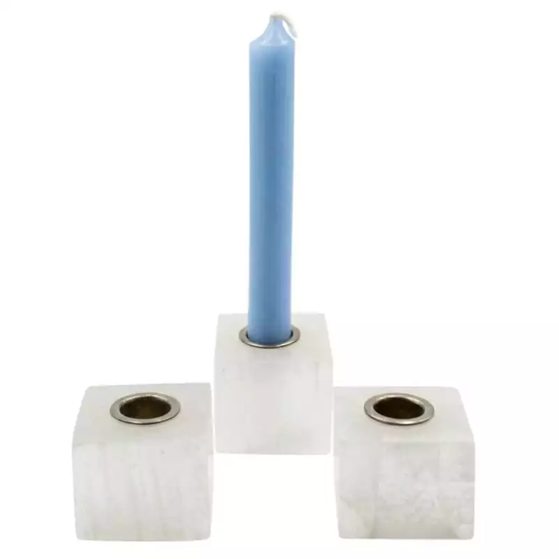 Set of three natural selenite crystal chime candle holders arranged together, showing white fibrous selenite with cylindrical tops sized for chime candles