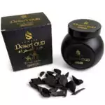 Jar of Sonavi Desert Oud bakhoor incense chips next to its decorative box, with small oud wood pieces scattered around — 40g natural agarwood blend inspired by desert nights.