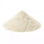 A small pile of pale cream-yellow gum arabic powder on a light surface, showing the fine ground texture of the acacia resin used for incense binding and ritual work.