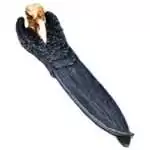Cold cast resin incense holder shaped as a black raven skull with pale bone-colored beak and spread wings extending down its 10-inch length, forming an ash-catching channel.