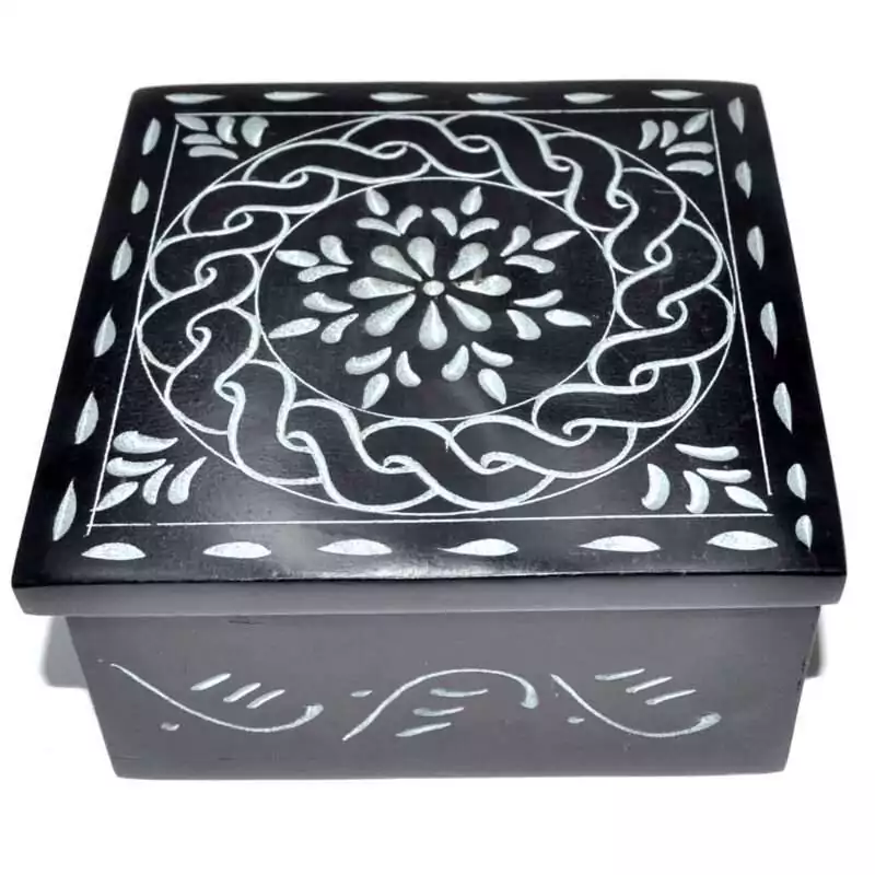 Black soapstone box with a hand-carved circular mandala design etched in pale lines across the lid, ringed by Celtic-style knotwork banding, approximately 4.25 inches square.