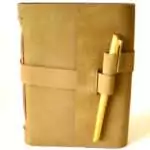 5 by 7 inch plain tan leather journal with wraparound cord closure and pen in front cover pen slot