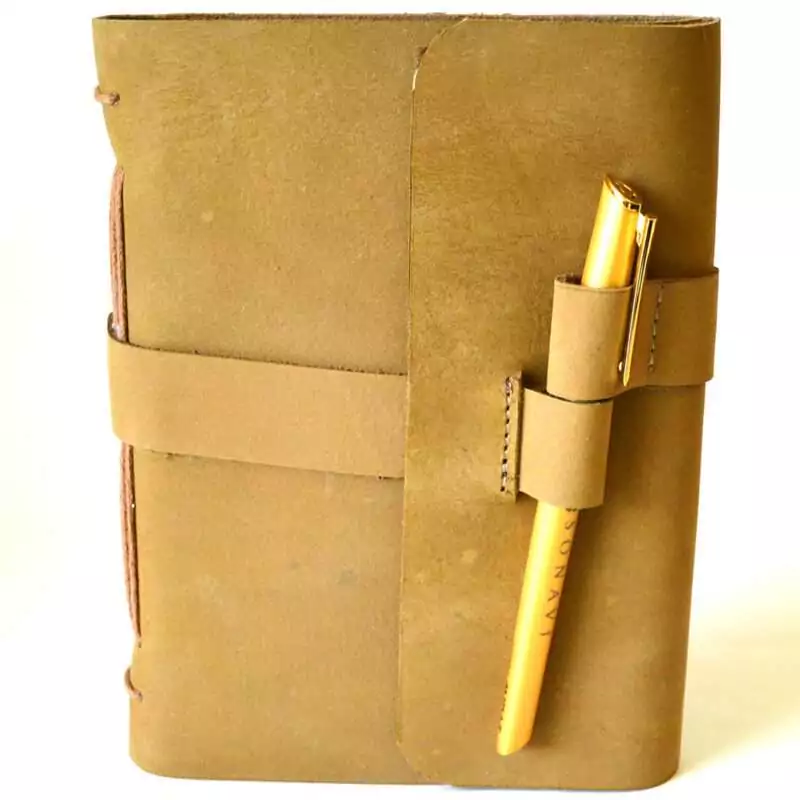 5 by 7 inch plain tan leather journal with wraparound cord closure and pen in front cover pen slot