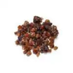 Small pile of glossy reddish-brown and dark amber myrrh resin tears of varied size on a plain white background.