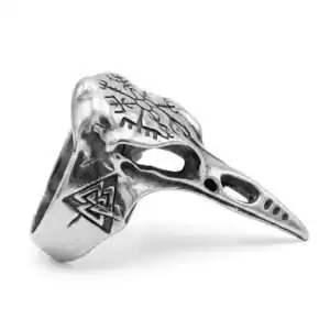 Oxidized pewter ring cast as a detailed raven skull with a long tapered beak extending down the finger, engraved with a Valknut symbol of three interlocking triangles near the band.