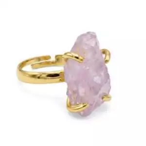 Gold-tone brass adjustable ring set with a raw, uncut translucent pink rose quartz crystal held by prong settings, shown against a white background.
