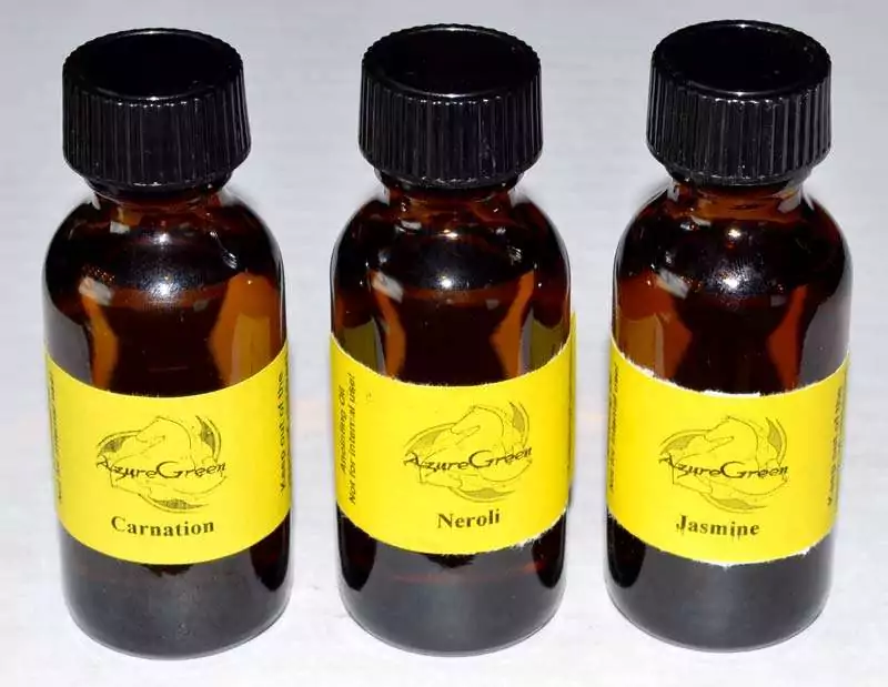 1oz-Lotus-Blossom-oil-azuregreen-OA1LOTB Three AzureGreen 1oz amber glass bottles of ritual aroma oil with black screw caps and yellow labels