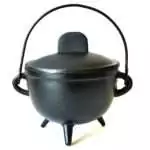 Black cast iron cauldron with a fitted lid, arched wire handle, two side loops, and three short legs, with a plain surface and no emblem, photographed on white