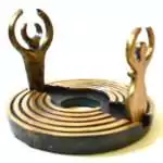 Dearinth Mini Altar: a round bronze-toned labyrinth base of concentric raised ridges with two upright cut-out figures, the Goddess and the God, arms raised in crescents, around an open center.