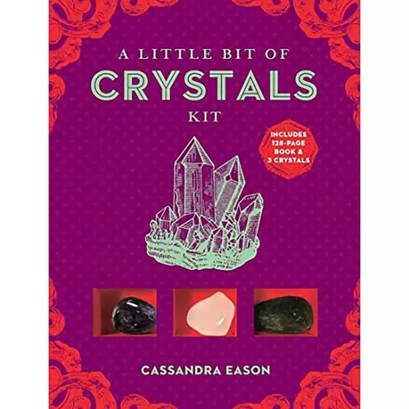 A Little Bit of Crystals Kit box by Cassandra Eason with a purple cover, a mint-green quartz cluster drawing and three tumbled stones shown in red compartments