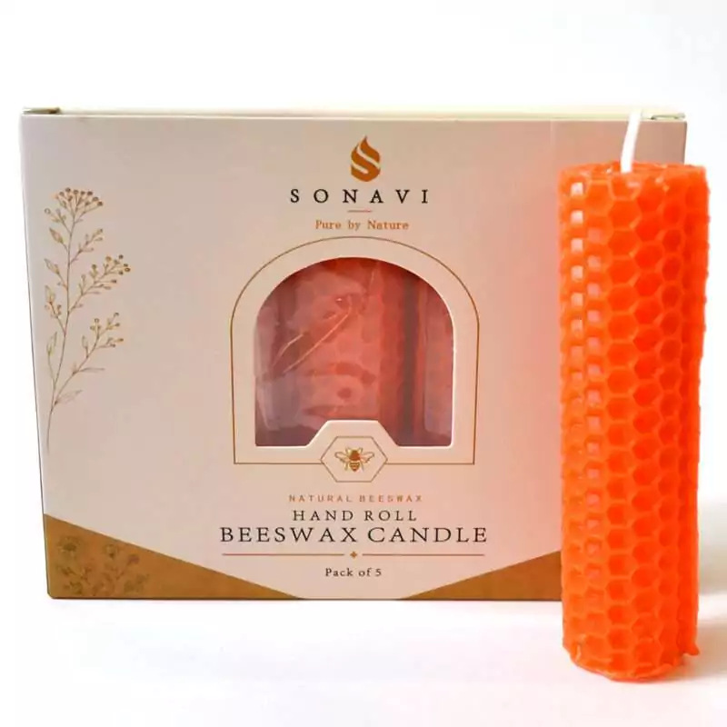 Bright orange hand-rolled honeycomb beeswax candle with a white wick, standing beside its cream box marked Natural Beeswax Hand Roll Beeswax Candle, Pack of 5