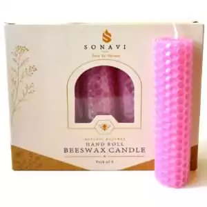 Soft pink hand-rolled honeycomb beeswax candle with a white wick, standing in front of its cream box marked Natural Beeswax Hand Roll Beeswax Candle, Pack of 5