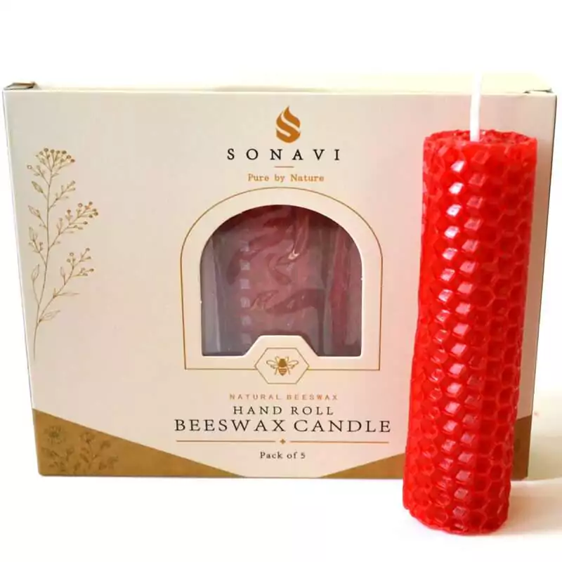 Bright red hand-rolled honeycomb beeswax candle with a white wick, standing in front of its cream box marked Natural Beeswax Hand Roll Beeswax Candle, Pack of 5