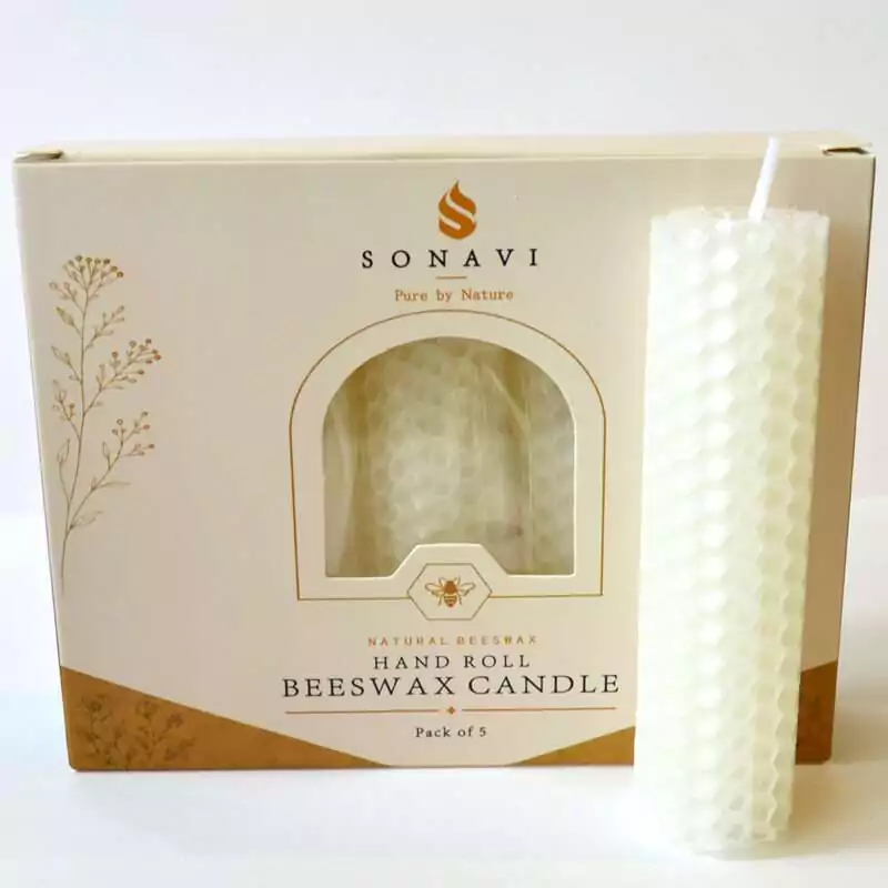 set-of-5-4quot-White-beeswax-candles-CSB4W Creamy white hand-rolled honeycomb beeswax candle with a white wick, standing in front of its cream box marked Natural Beeswax Hand Roll Beeswax Candle, Pack of 5