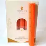 Bright orange 8 inch hand-rolled honeycomb beeswax candle with a white wick standing in front of its cream box marked Natural Beeswax Hand Roll Beeswax Candle, Pack of 5