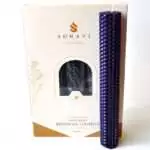 Deep purple 8 inch hand-rolled honeycomb beeswax candle with a white wick standing in front of its cream box marked Natural Beeswax Hand Roll Beeswax Candle, Pack of 5