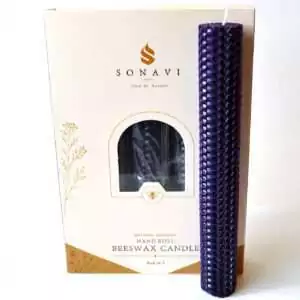 Deep purple 8 inch hand-rolled honeycomb beeswax candle with a white wick standing in front of its cream box marked Natural Beeswax Hand Roll Beeswax Candle, Pack of 5
