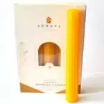 Golden yellow 8 inch hand-rolled honeycomb beeswax candle with a white wick standing in front of its cream box marked Natural Beeswax Hand Roll Beeswax Candle, Pack of 5