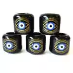 Set of five black ceramic Evil Eye candle holders stacked in a pyramid, each with a gold-lined eye, a blue and white iris and a black pupil