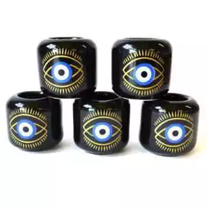 Set of five black ceramic Evil Eye candle holders stacked in a pyramid, each with a gold-lined eye, a blue and white iris and a black pupil