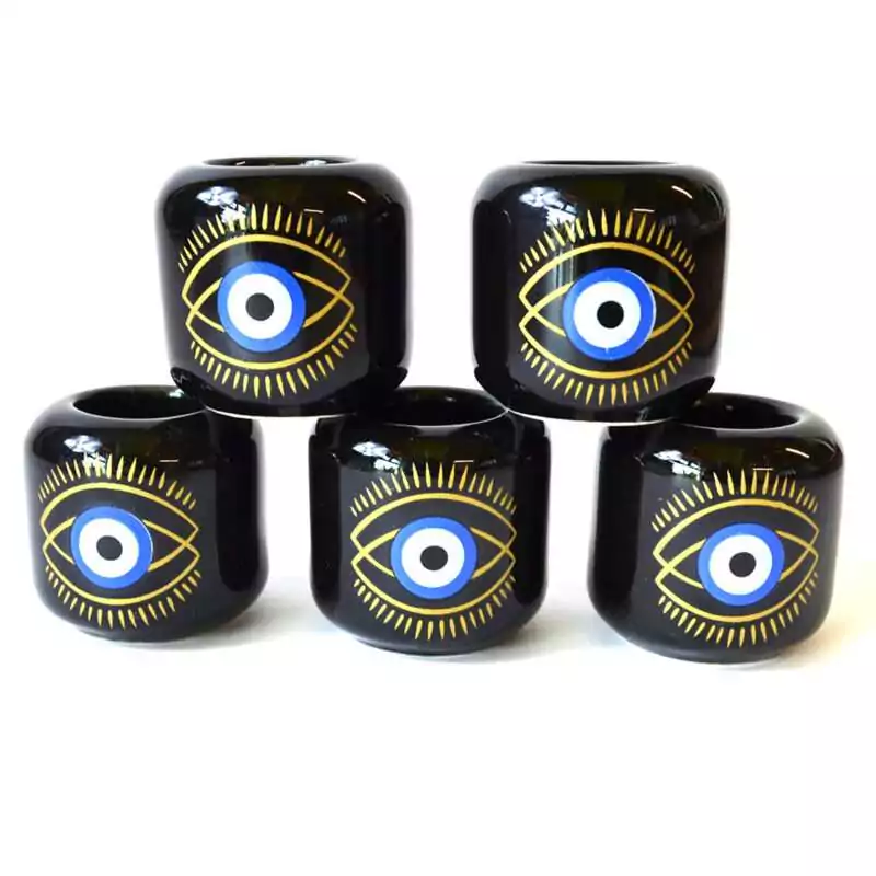 set-of-5-Evil-Eye-Black-ceramic-holder-CHEE Set of five black ceramic Evil Eye candle holders stacked in a pyramid, each with a gold-lined eye, a blue and white iris and a black pupil