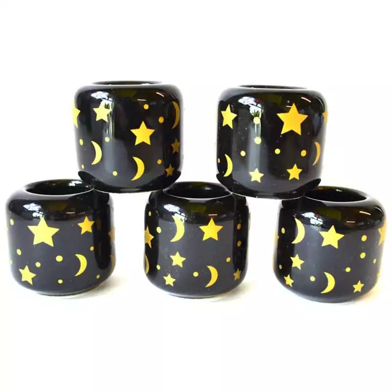 set-of-5-Stars-Moon-Black-ceramic-holder-CHSM Set of five black ceramic Stars and Moon candle holders stacked in a pyramid, scattered with gold stars, crescent moons and dots