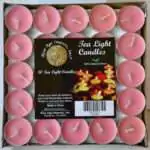 Square tray of 50 soft rose-pink tea light candles under clear wrap, each in a small metal cup with a pale wick, with a pack label reading Tea Light Candles and 50 Tea Light Candles