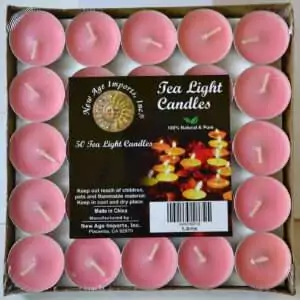 Square tray of 50 soft rose-pink tea light candles under clear wrap, each in a small metal cup with a pale wick, with a pack label reading Tea Light Candles and 50 Tea Light Candles