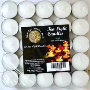 Tray of 50 white candles in metal cups wrapped in clear film, each with a rounded top and a white wick, with a pack label reading Tea Light Candles and 50 Tea Light Candles